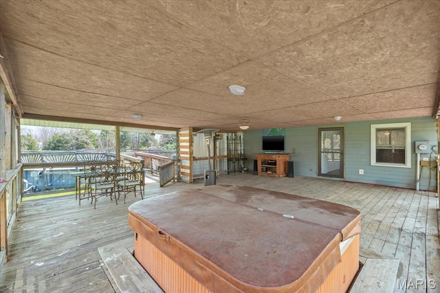 deck with a hot tub and exterior bar