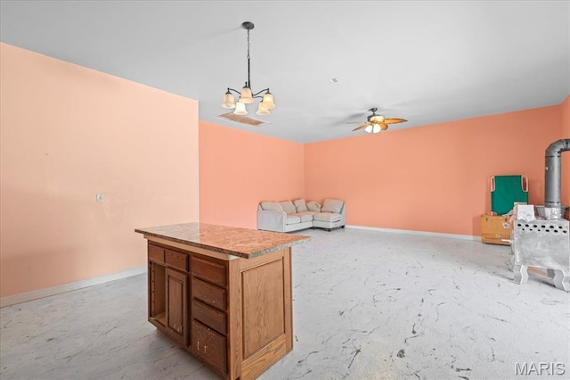 unfurnished room featuring unfinished concrete floors, a chandelier, ceiling fan, and baseboards