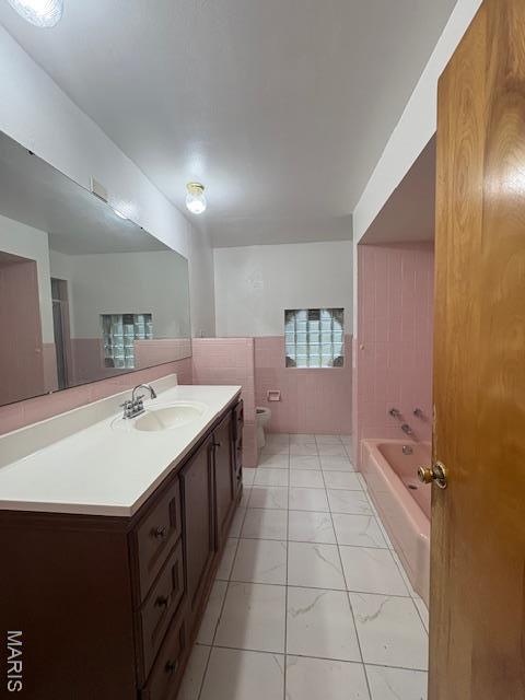 26 Ranchview Dr, Florissant, MO 63033 - full bathroom with marble finish flooring, vanity, a tub to relax in, and toilet