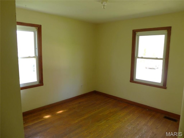 340 Wedge Dr, Saint Louis, MO 63135 - unfurnished room with plenty of natural light, wood finished floors, and baseboards