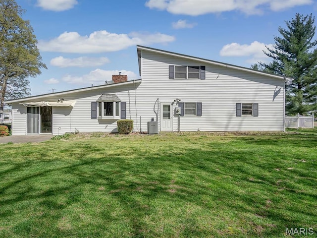 4522 Meadow Ln, Red Bud, IL 62278 - rear view of house with central air condition unit, a chimney, and a yard