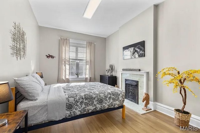 3313 Magnolia Ave, Saint Louis, MO 63118 - bedroom featuring wood finished floors and a fireplace