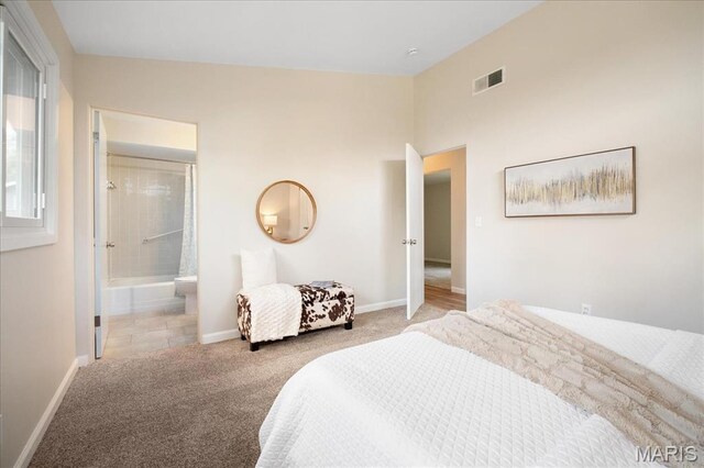 3105 Newgate Dr, Florissant, MO 63033 - carpeted bedroom with baseboards and ensuite bath