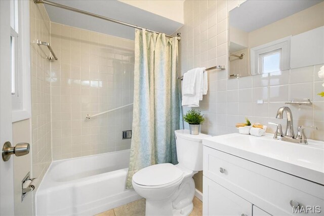 3105 Newgate Dr, Florissant, MO 63033 - full bathroom featuring toilet, shower / tub combo with curtain, backsplash, vanity, and tile patterned floors