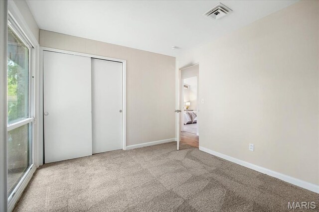 3105 Newgate Dr, Florissant, MO 63033 - unfurnished bedroom with carpet floors, baseboards, and a closet