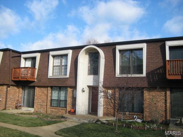 1167 Appleseed Ln Unit D, Olivette, MO 63132 - view of property featuring brick siding, a balcony, and mansard roof