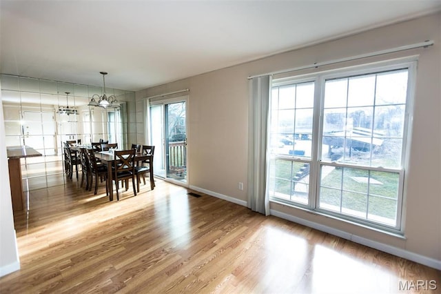 1167 Appleseed Ln Unit D, Olivette, MO 63132 - dining area featuring light wood-style flooring, baseboards, and a chandelier