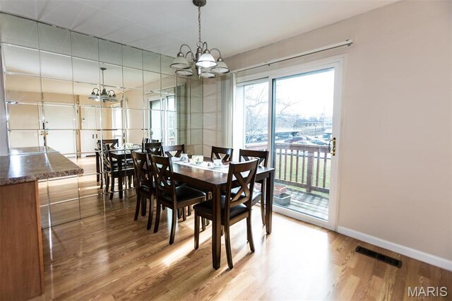 1167 Appleseed Ln Unit D, Olivette, MO 63132 - dining room featuring a chandelier, wood finished floors, and baseboards
