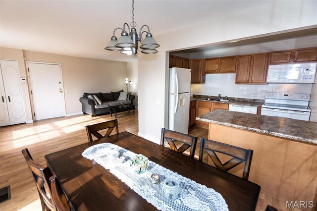 1167 Appleseed Ln Unit D, Olivette, MO 63132 - dining space with a chandelier, wood finished floors, and baseboards