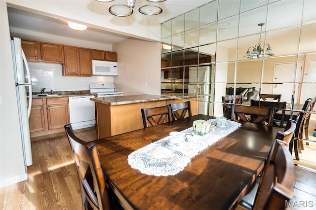 1167 Appleseed Ln Unit D, Olivette, MO 63132 - dining area featuring wood finished floors and a chandelier