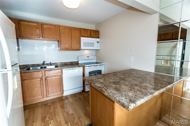 1167 Appleseed Ln Unit D, Olivette, MO 63132 - kitchen with white appliances, a sink, dark wood finished floors, brown cabinets, and decorative backsplash