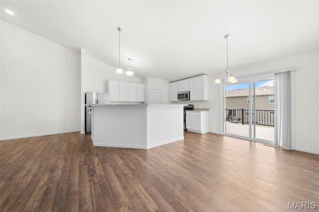 5341 Trailhead Ct, Eureka, MO 63025 - kitchen featuring appliances with stainless steel finishes, wood finished floors, a chandelier, white cabinetry, and lofted ceiling