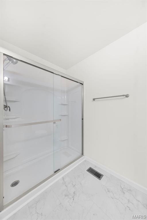 5341 Trailhead Ct, Eureka, MO 63025 - bathroom with marble look tile flooring, a shower stall, and baseboards