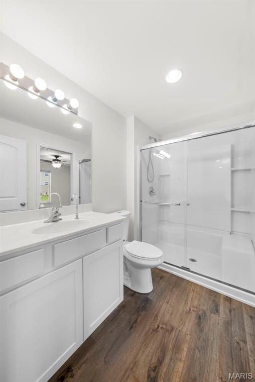 5341 Trailhead Ct, Eureka, MO 63025 - full bathroom featuring wood finished floors, vanity, ceiling fan, an enclosed shower, and toilet