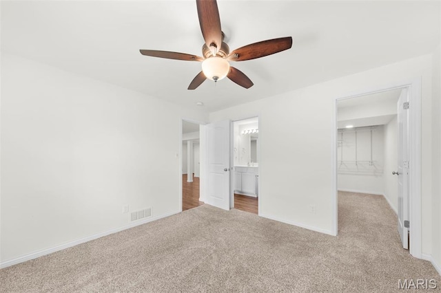 5341 Trailhead Ct, Eureka, MO 63025 - unfurnished bedroom with light colored carpet, a walk in closet, baseboards, ensuite bathroom, and a closet