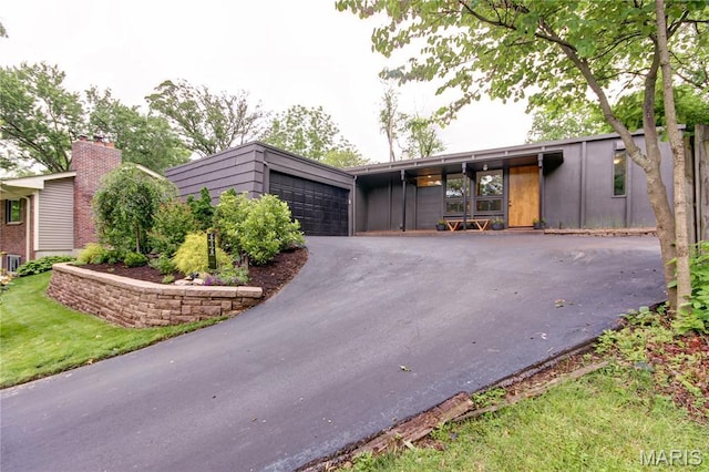 616 Hickory Hollow Ln, Saint Louis, MO 63122 - mid-century modern home featuring asphalt driveway and an attached garage