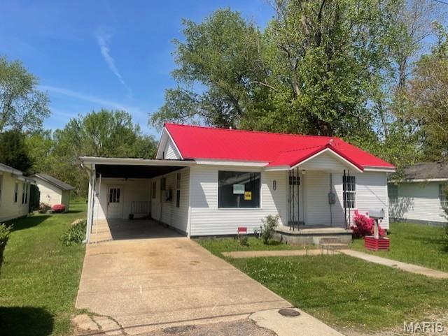 2317 Pike St, Poplar Bluff, MO 63901 - bungalow with covered porch, driveway, a front yard, an attached carport, and metal roof