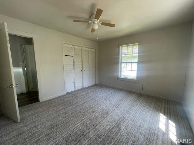 2317 Pike St, Poplar Bluff, MO 63901 - unfurnished bedroom with baseboards, carpet floors, a closet, and a ceiling fan