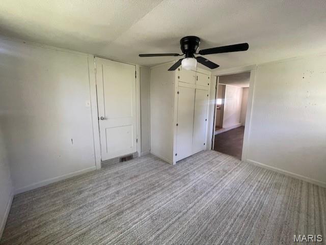 2317 Pike St, Poplar Bluff, MO 63901 - unfurnished bedroom featuring carpet flooring, baseboards, a ceiling fan, and a closet