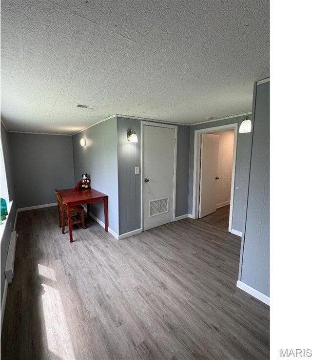 61 Pine Trl, Fairview Heights, IL 62208 - empty room featuring wood finished floors, a textured ceiling, and baseboards