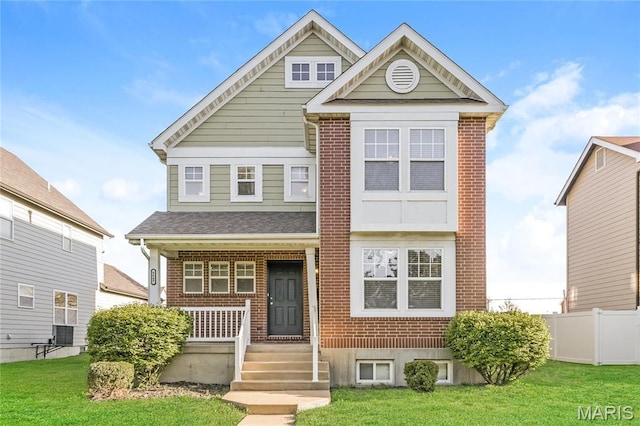 4007 Lafayette Ave, Saint Louis, MO 63110 - view of front of home with covered porch, brick siding, cooling unit, and roof with shingles