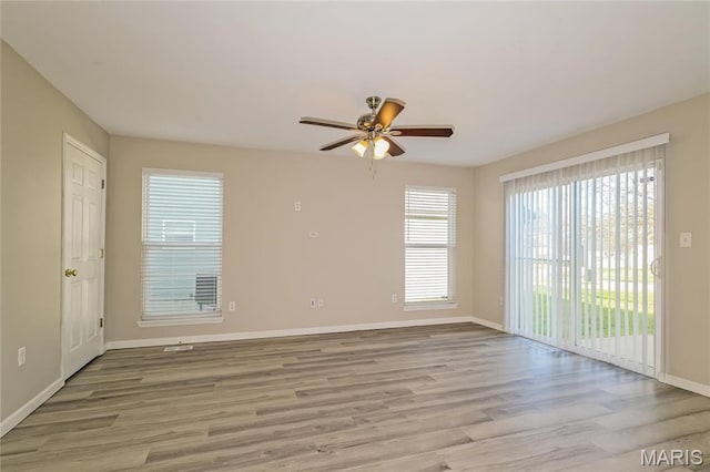 4007 Lafayette Ave, Saint Louis, MO 63110 - spare room featuring a ceiling fan, light wood-style floors, and baseboards