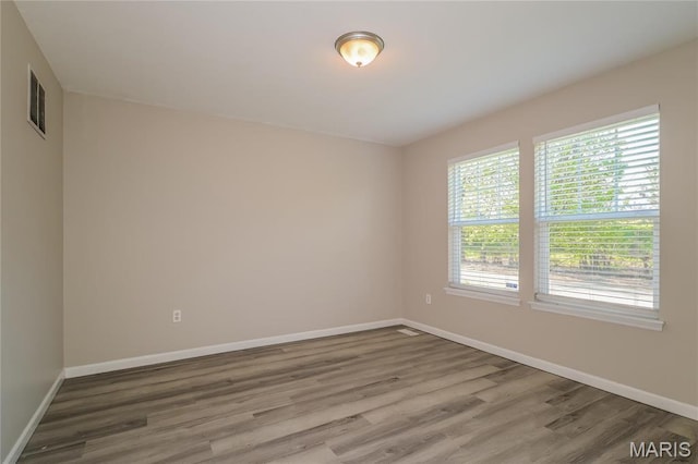4007 Lafayette Ave, Saint Louis, MO 63110 - unfurnished room with wood finished floors and baseboards