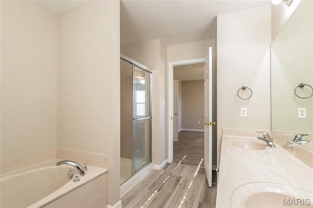 4007 Lafayette Ave, Saint Louis, MO 63110 - bathroom with a shower stall, a bath, wood finished floors, and double vanity