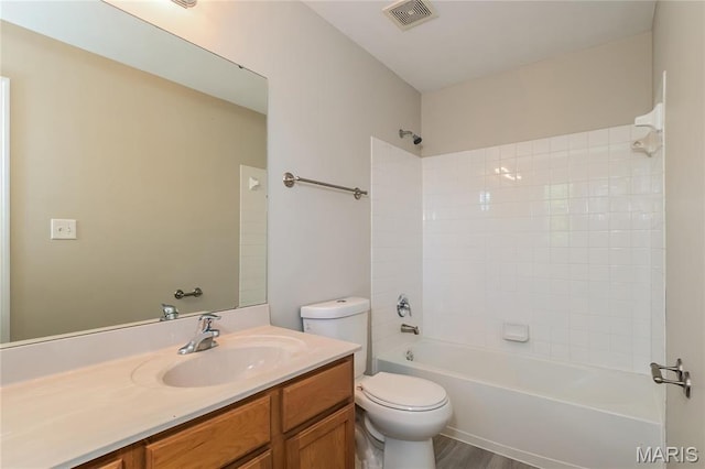 4007 Lafayette Ave, Saint Louis, MO 63110 - bathroom with toilet, vanity, shower / bathtub combination, and wood finished floors