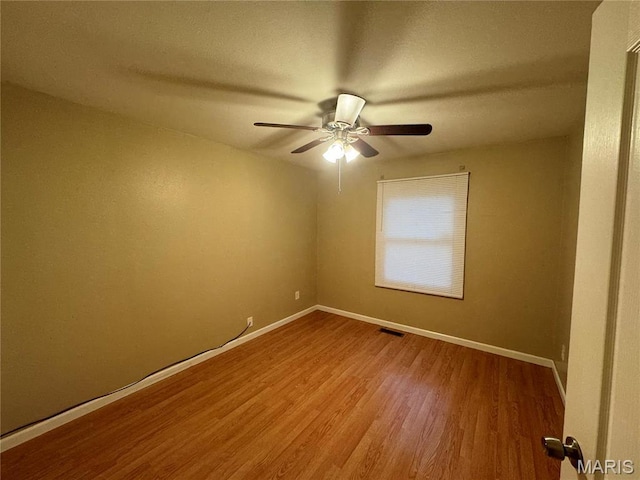 1731 Atmore Dr, Saint Louis, MO 63136 - spare room featuring wood finished floors, ceiling fan, and baseboards