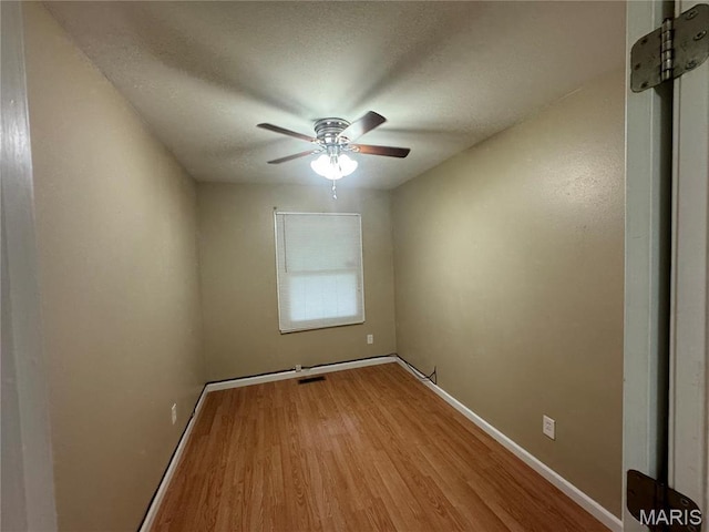 1731 Atmore Dr, Saint Louis, MO 63136 - empty room with wood finished floors, ceiling fan, baseboards, and a textured ceiling