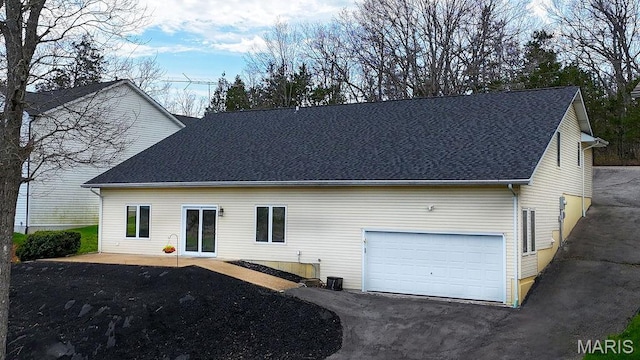 632 N Lafitte Dr, Bonne Terre, MO 63628 - rear view of house with a shingled roof and asphalt driveway