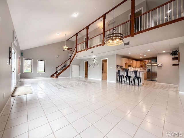 632 N Lafitte Dr, Bonne Terre, MO 63628 - unfurnished living room with high vaulted ceiling, a ceiling fan, light tile patterned flooring, baseboards, and recessed lighting