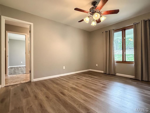 632 N Lafitte Dr, Bonne Terre, MO 63628 - empty room with ceiling fan, baseboards, and dark wood-style floors