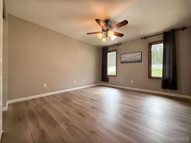 632 N Lafitte Dr, Bonne Terre, MO 63628 - spare room featuring plenty of natural light, ceiling fan, wood finished floors, and baseboards