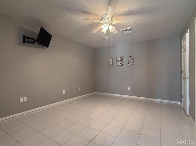 632 N Lafitte Dr, Bonne Terre, MO 63628 - unfurnished room featuring a ceiling fan, a drop ceiling, baseboards, and light tile patterned floors