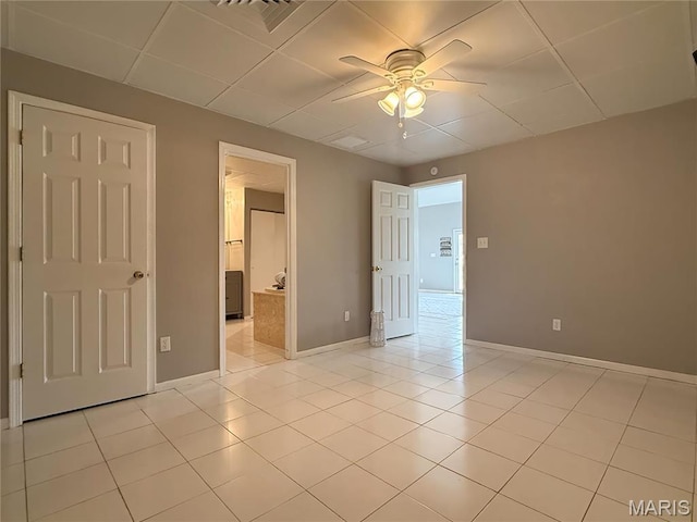 632 N Lafitte Dr, Bonne Terre, MO 63628 - unfurnished bedroom with a drop ceiling, light tile patterned floors, baseboards, and ceiling fan
