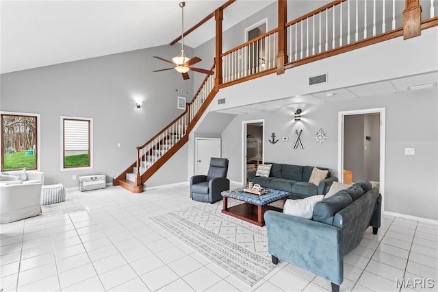 632 N Lafitte Dr, Bonne Terre, MO 63628 - tiled living area with high vaulted ceiling, stairs, ceiling fan, and baseboards