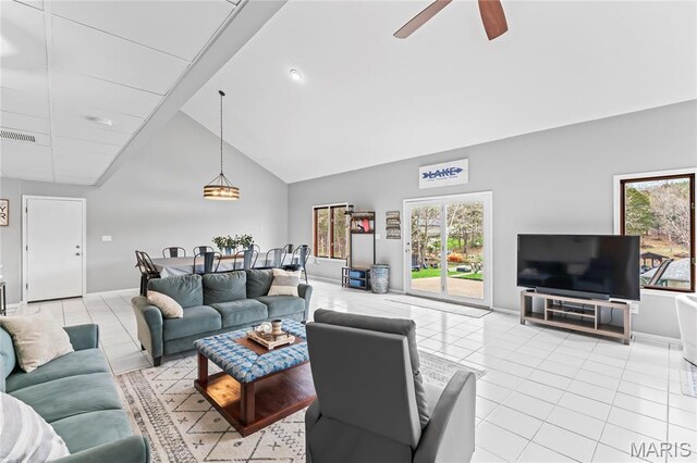 632 N Lafitte Dr, Bonne Terre, MO 63628 - living area with high vaulted ceiling, light tile patterned floors, a ceiling fan, and baseboards