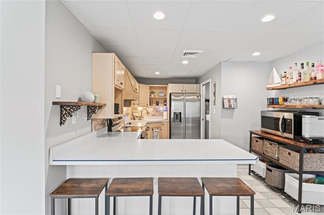 632 N Lafitte Dr, Bonne Terre, MO 63628 - kitchen featuring appliances with stainless steel finishes, open shelves, a peninsula, light countertops, and recessed lighting