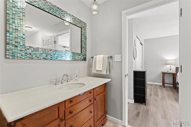 632 N Lafitte Dr, Bonne Terre, MO 63628 - bathroom with vanity, baseboards, and wood finished floors