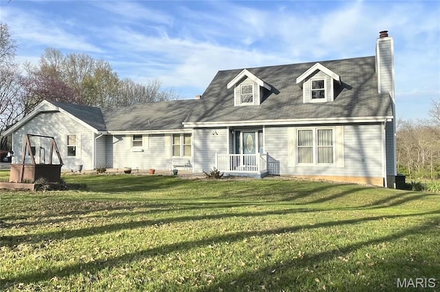 cape cod house with a chimney and a front yard