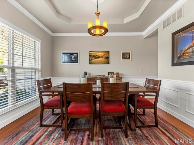 1509 Cedar Ridge Dr, Ofallon, IL 62269 - dining area featuring wood finished floors, plenty of natural light, a tray ceiling, wainscoting, and a chandelier