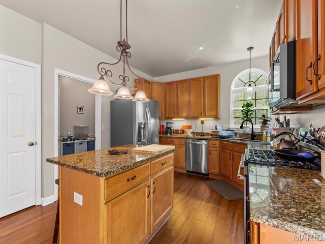 1509 Cedar Ridge Dr, Ofallon, IL 62269 - kitchen featuring stainless steel appliances, a sink, a center island, dark wood-style flooring, and dark stone counters