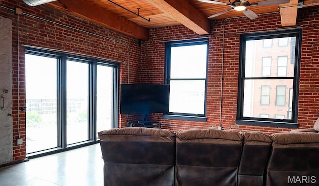 1015 Washington Ave Unit 507, Saint Louis, MO 63101 - living area featuring wooden ceiling, beam ceiling, brick wall, and a ceiling fan