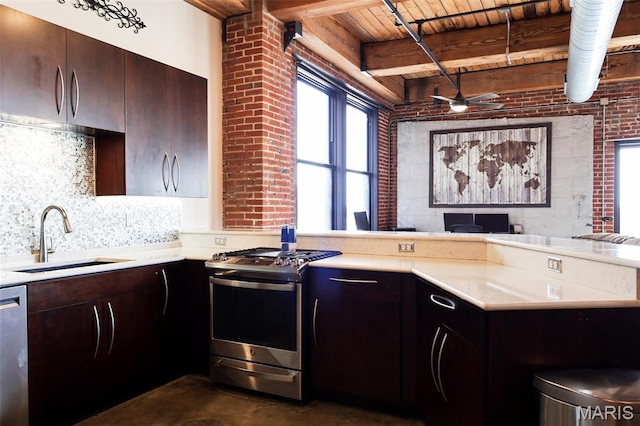 1015 Washington Ave Unit 507, Saint Louis, MO 63101 - kitchen featuring appliances with stainless steel finishes, a sink, light countertops, a peninsula, and wooden ceiling