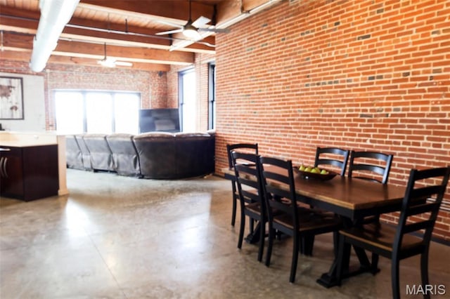 1015 Washington Ave Unit 507, Saint Louis, MO 63101 - dining room with brick wall, ceiling fan, finished concrete flooring, and beam ceiling