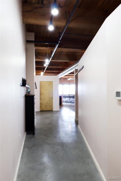 1015 Washington Ave Unit 507, Saint Louis, MO 63101 - hallway with wood ceiling, baseboards, finished concrete floors, and beamed ceiling