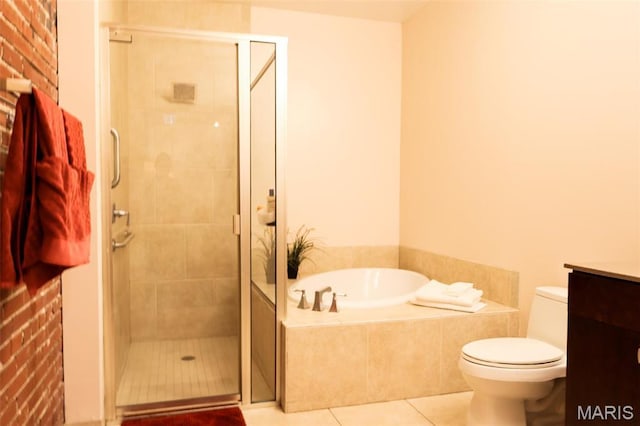 1015 Washington Ave Unit 507, Saint Louis, MO 63101 - bathroom with tile patterned flooring, a bath, a shower stall, and toilet