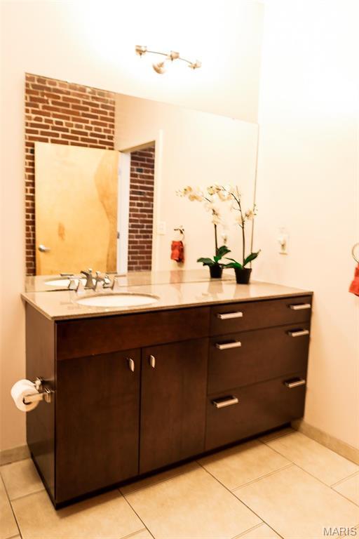1015 Washington Ave Unit 507, Saint Louis, MO 63101 - bathroom featuring vanity, tile patterned floors, and baseboards
